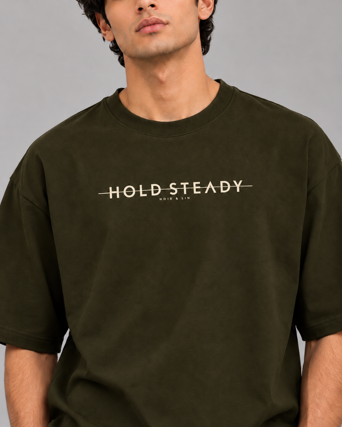 Noir & Lin HOLD STEADY oversized graphic tee in Olive Green, model portrait (AI-generated model image)